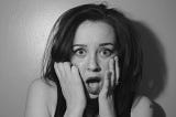 Black and white photo of a woman in shock