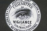 The symbol of the committee of vigilance, an all seeing eye with “committee of vigilance San Francisco” and mottos.