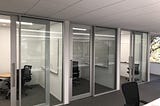 a row of offices with sliding glass doors, with whiteboards, in an Apple office in Cupertino. Having offices with doors is probably why Apple is a trillion dollar company, I’m sure of it.