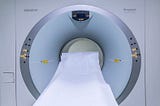 An MRI scanner with a white sheet