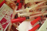 A pile of syringes used to administer insulin and alcohol swabs