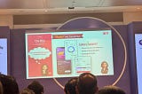 A presentation slide for Simplinvest displayed on a large screen at Global Fintech Fest 2025, with an audience visible in the foreground. The slide is titled “Build My Tomorrow” and features the Simplinvest logo alongside three key highlights: “First of its kind SIP Platform,” “Power of Diversification,” and “Starting at Rs 1,000.” The left panel poses the question “Why should SIP be limited to Mutual Funds?” under the heading “The Why: Customer Need.” The center shows mobile app screens illustr