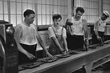 Still from the motion picture ‘Modern Times’ from Charles Chaplin showing a worker on a manufacture line.