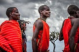 What should you anticipate when visiting a Maasai Village in Tanzania?