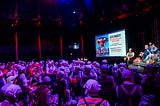 a gaggle of Gumbies attend a Monty Python show, attired like the popular clownish characters in sketches from the UK TV series Monty Python’s Flying Circus