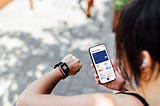 Lady checking her fitness watch and fitness app