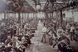 Factory workers under supervision of a central manager during the industrial revolution.