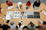 people generate ideas with colored cards on a wooden table