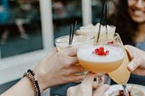 person holding filled drinking glasses