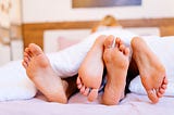 Lovers having sex under blanket at day