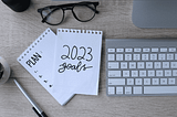 Computer keyboard and notepad with note about 2023 goals. This candidate is considering how job hunting will be different in 2023.