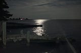 The Blue Supermoon illuminates the night sky and shimmers in the water as it rises over the Long Island Sound.