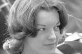 A black and white picture of Romy Schneider’s face in 1959 in Italy, on a movie set