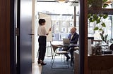 Coworkers looking at documents in an office