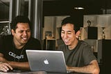 Colleagues deep in conversation in front of a laptop