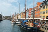 Colorful buildings along canal with boats docked