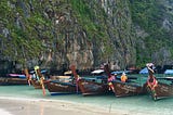 Boats parked on the famous beach of beautiful Ko Phi Phi in Thailand