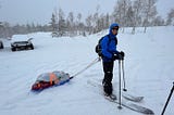 Splitboarder pulling sled or pulk to Boundary Creek Yurt in the Uintas