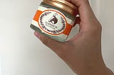 Rose gold cover top for clear jar with orange and light beige white sticker with horse logo