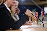 Woman at a conference speaking into a microphone