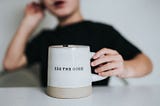 A mug with the words SEE THE GOOD engraved on its side