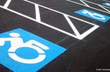 Photo: Disabled Parking Spaces with the new Accessible Icon, Credit Disability Scoop