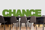 A conference table with empty chairs with ‘CHANCE” writen above