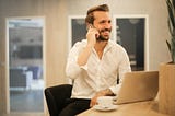 A man making a call at the office.