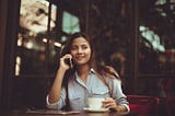 Young woman at a cafe speaking on the phone