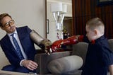 An image of Alex Pring, a 7-year-old boy with a newly-given Iron Man themed prosthetic arm, sharing a fist-bump with Robert Downey Jr., famously known for playing Tony Stark (Iron Man) in Marvel Movies.