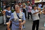 Senior Japanese people training outside.