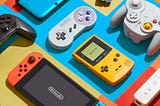 A color photo by Brandon Hill of a colorful still life arrangement of Nintendo products.