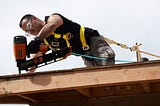 Roofing nail gun in action