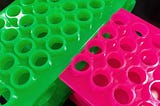 Photo by Author — colourful test-tube racks in the lab