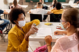 New York teacher assisted student wearing mask during COVID-19 pandemic