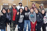 An image of participants in About Face’s training at Cheyenne River, smiling on a snowy day.