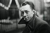 Albert Camus smoking a cigarrate.