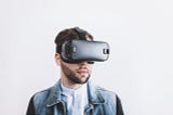 Man wearing cellphone-enabled virtual reality head mounted display.