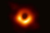 The first photograph of a black hole. It looks like a dark circle with a ring of light around it.
