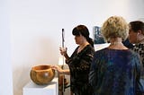Dr. Cheryl Fogle-Hatch touching “White Ash Burl Bowl with Bark On” carved by George Wurtzel in 2019. Photo by Christine Qabar