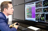 man focused on monitoring his trades