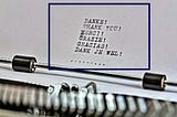 Paper coming out of a typewriter on which the word thank you has been typed in various languages