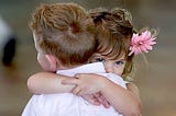 Two children hugging each other