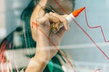 A business woman points to process metric graphs
