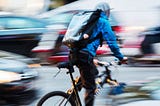 A NYC bike deliverer navigating the busy streets of the City.