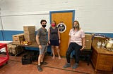 People next to donations in a food pantry