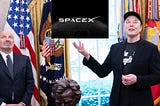 Elon Musk holding up the SpaceX logo