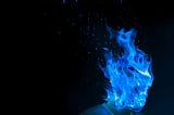 Man in a vest with blue flame completely engulfing his head. The words Psychodrama are stylized above it.