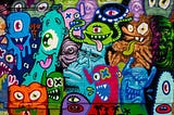 Brightly coloured street art of aliens and monsters