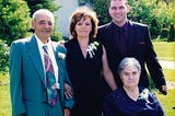 Your author stands with his wife and her parents, dressed up for a wedding
